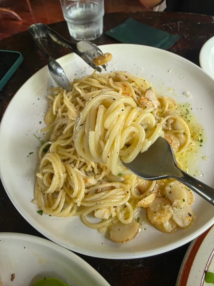 Fork lifting a bite of the Sunny Garlic Pasta noodles