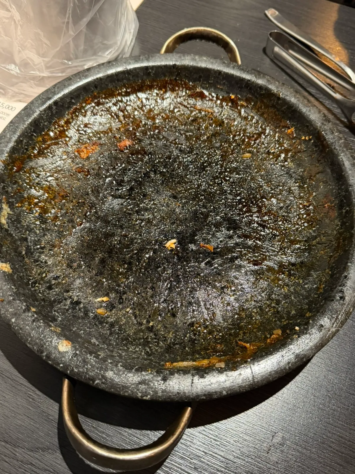 Cheese crust stuck to the stone plate next to the finished half-and-half chicken