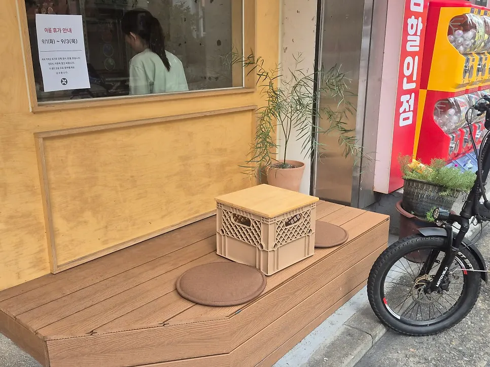 Exterior view with outdoor seating at Sese Coffee
