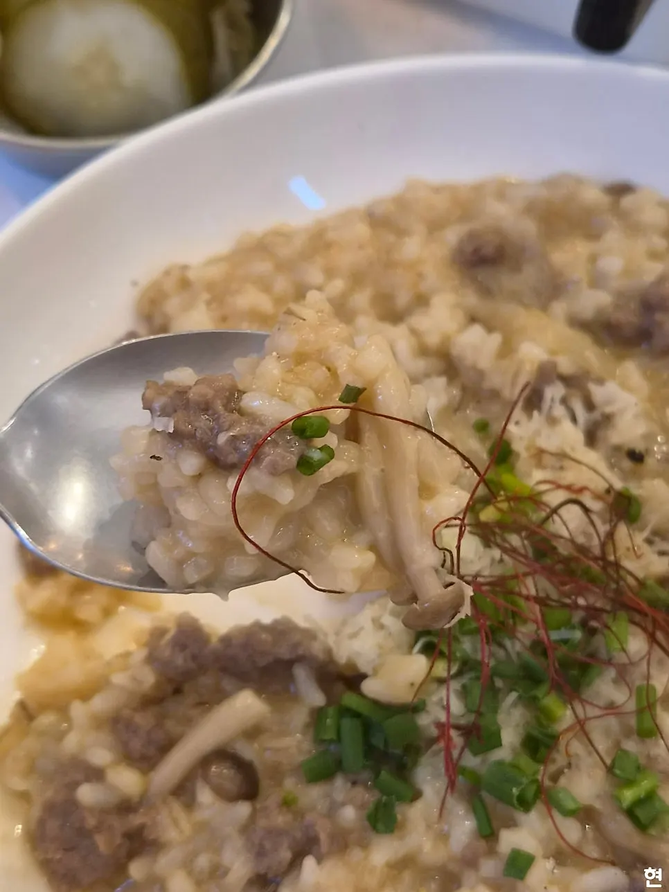 Close-up of bulgogi risotto with enoki mushrooms