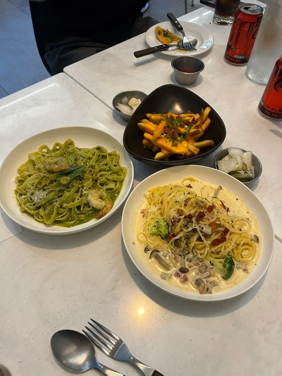 Pizza, pasta and fries set out on the table