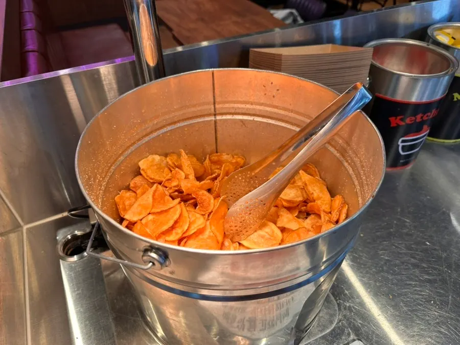 Crispy potato chips piled at the self-serve corner