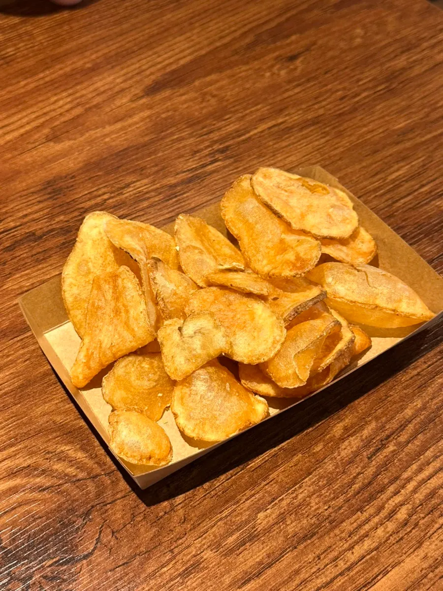 A shared plate of chips between two people