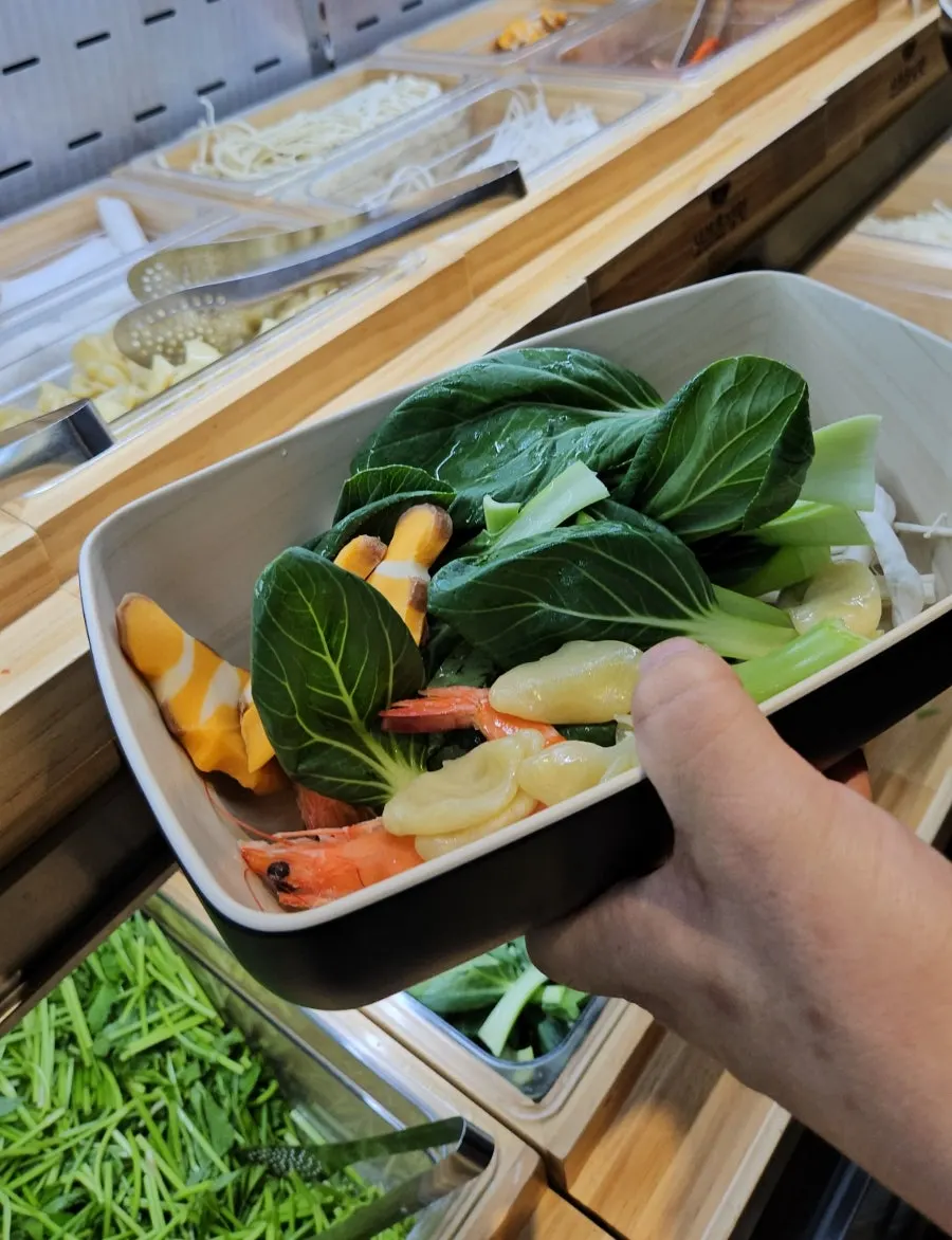 Sujebi and seafood laid out at the ingredients station