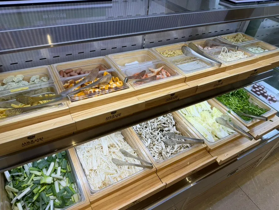 Display of napa cabbage, bok choy, and other shabu-shabu ingredients