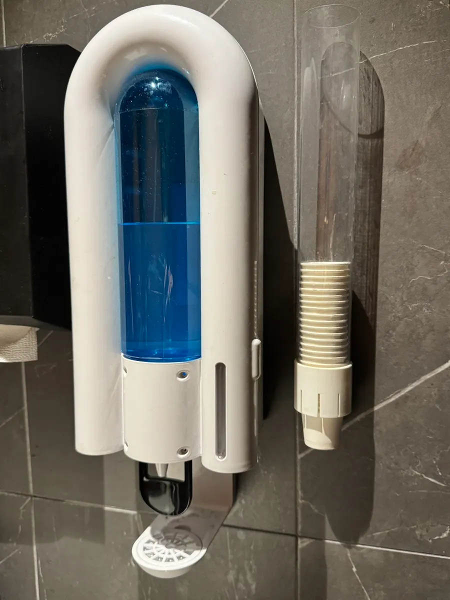 Restroom sink with mouthwash provided