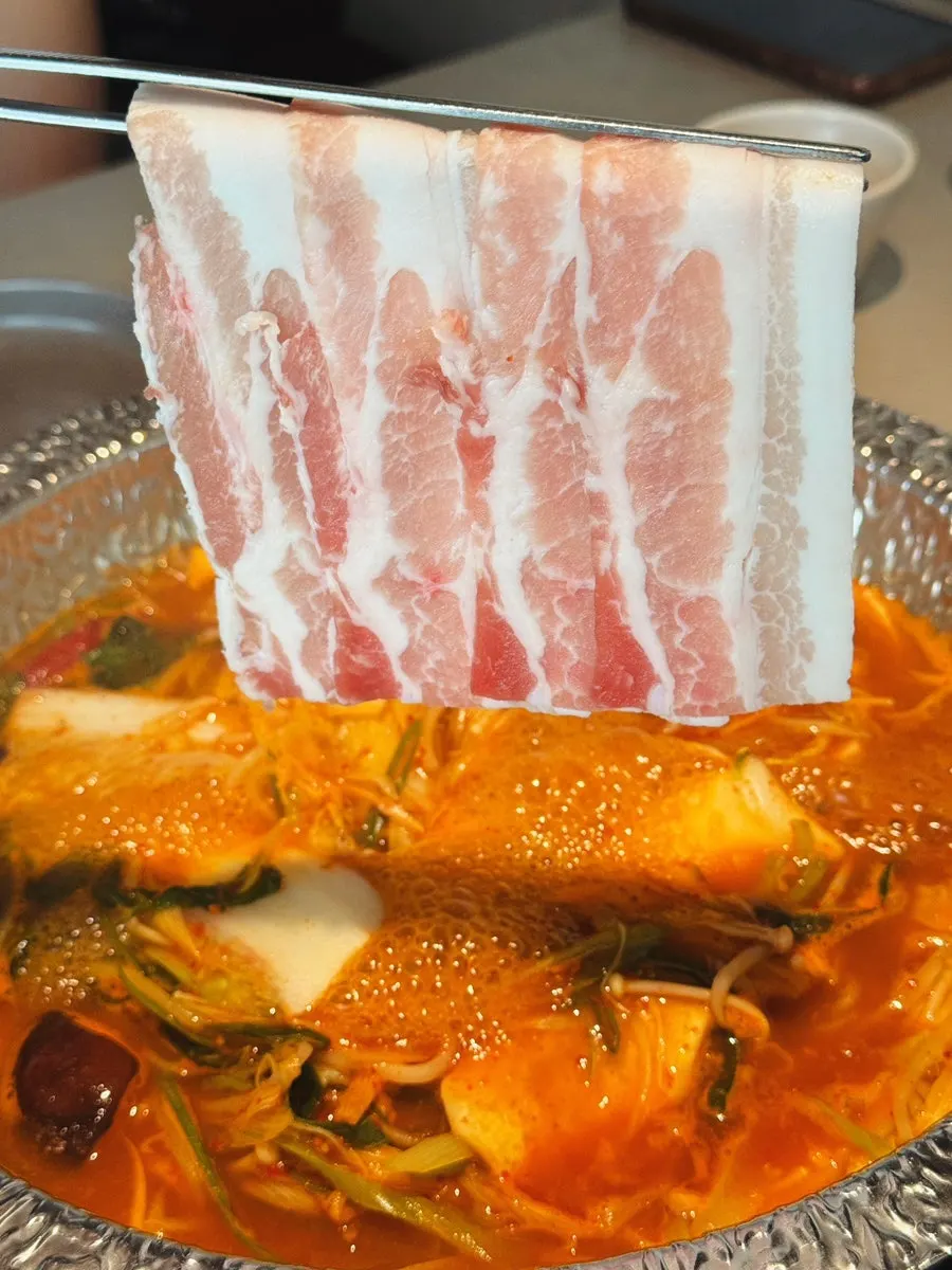 A piece of black pork belly cooked in the broth