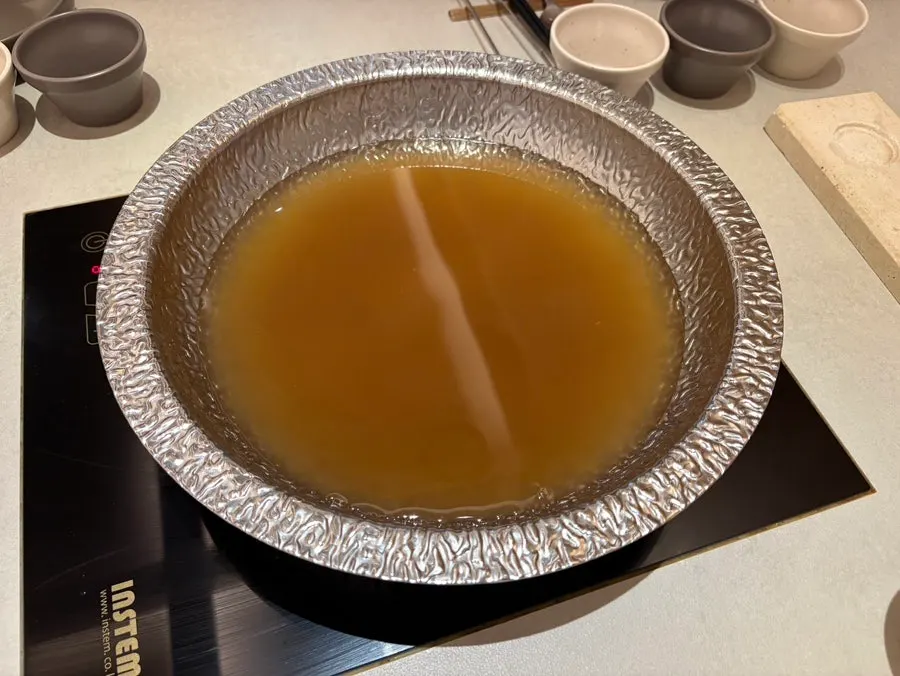 Yuzu soy sauce, chili sauce, and sesame dressing set up on the table