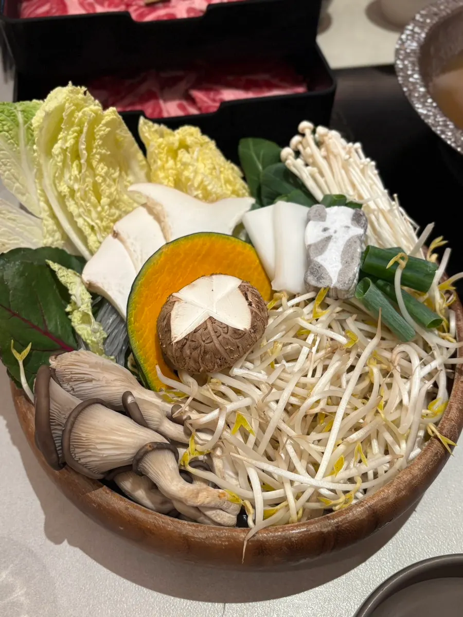 Adding vegetables into the bubbling broth