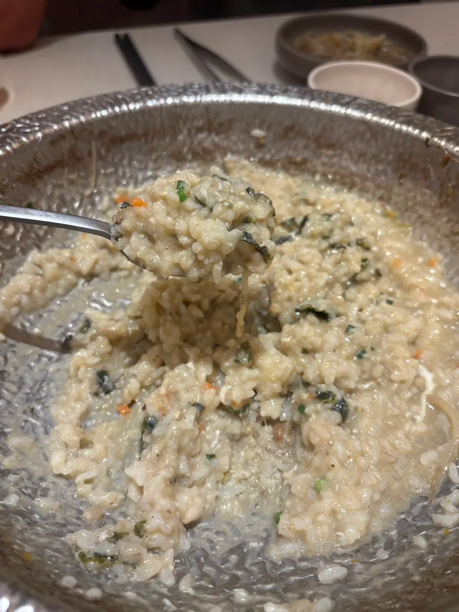 Egg porridge topped with sesame oil and seaweed flakes