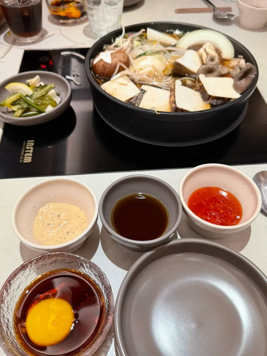 Sukiyaki pot with bok choy and bean sprouts added