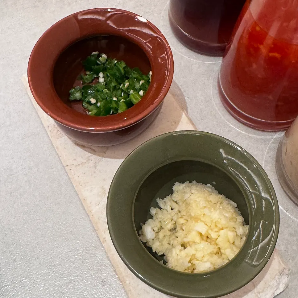 Close-up of yuzu soy sauce, chili, and sesame sauce