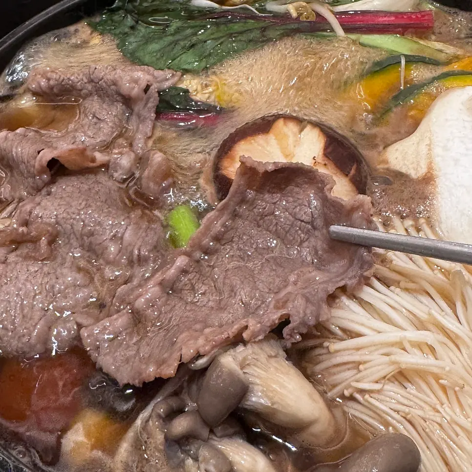 Vegetables cooking in the sukiyaki shabu-shabu pan