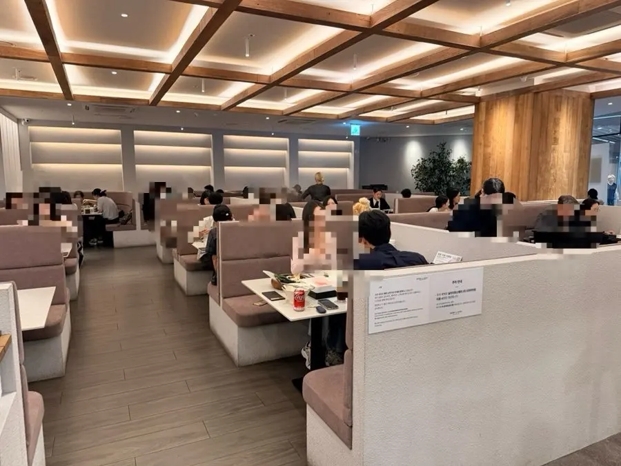 Interior of Shabu in Seoul Hapjeong Branch in white and wood tones