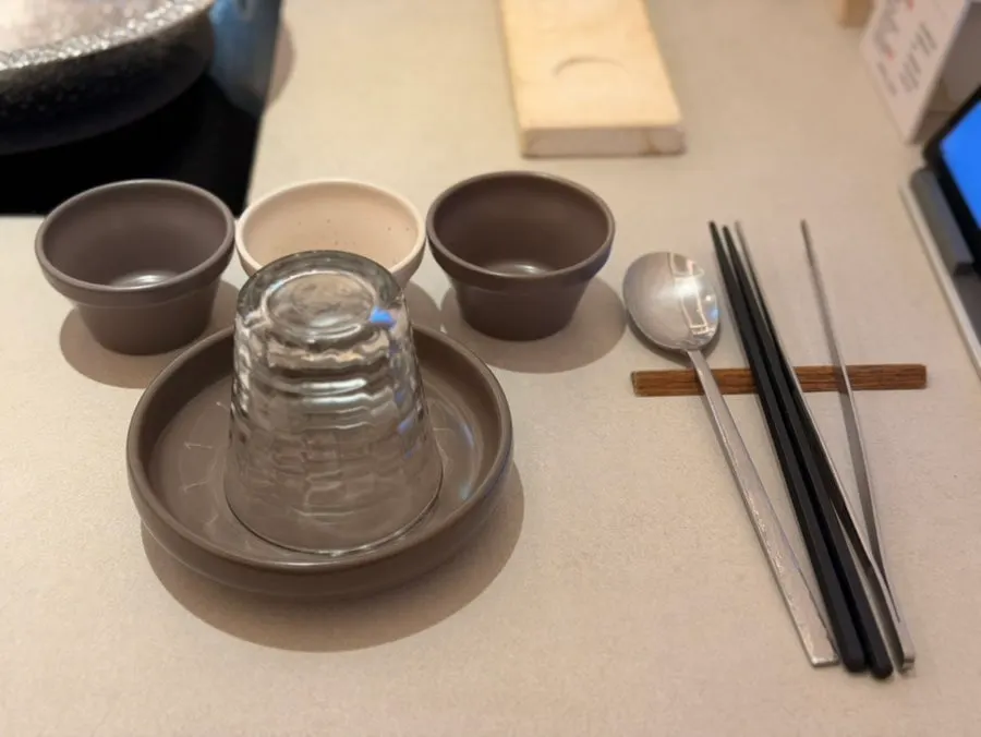 Basic table setting with sauce dishes, spoons, and tongs