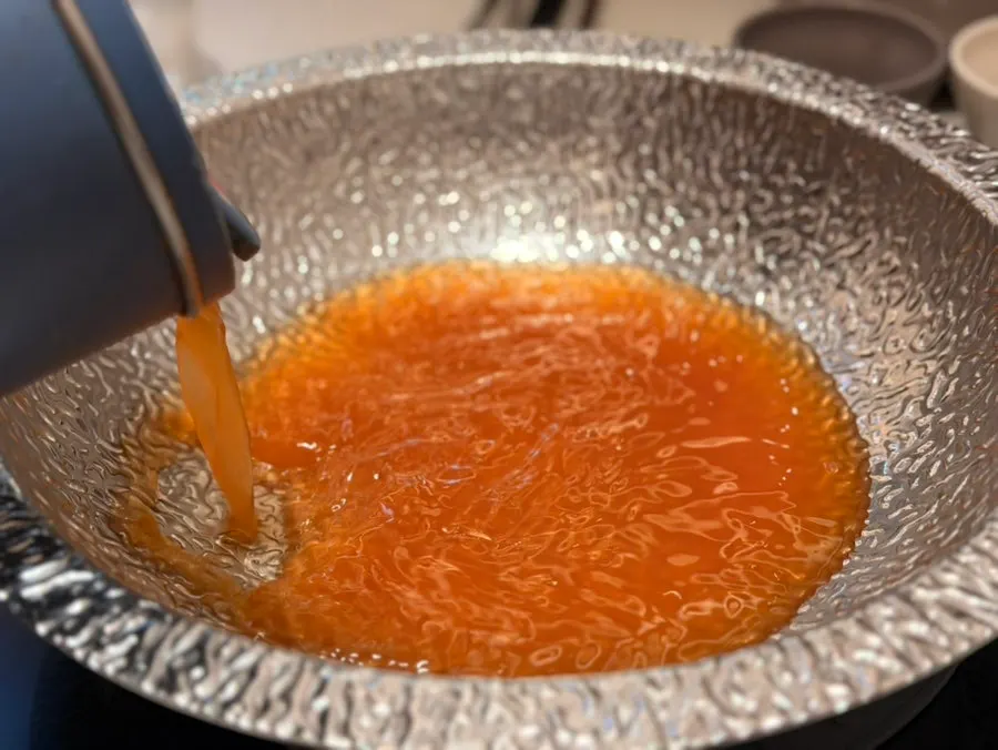 Spicy mushroom broth filled to the brim in the pot