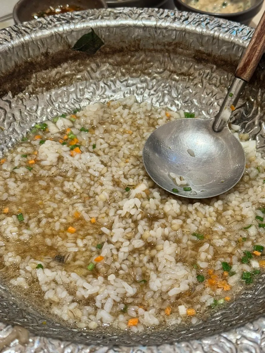 Egg porridge being cooked tableside
