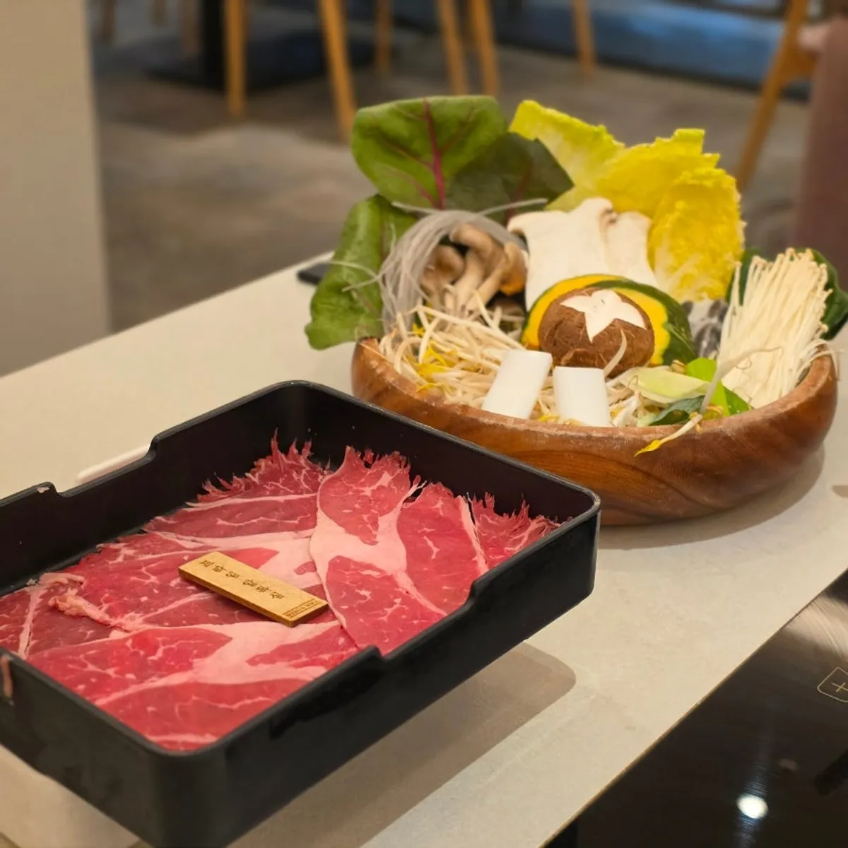 Assorted shabu-shabu vegetables including napa cabbage and mushrooms