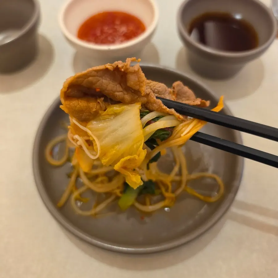 Dipping cooked meat into sauce