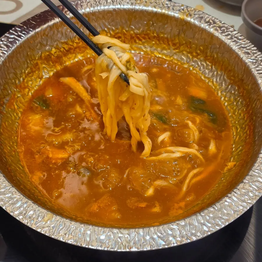 Kalguksu noodles boiled in the spicy mushroom broth