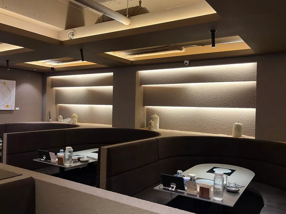 Interior seating decorated in black and wood tones