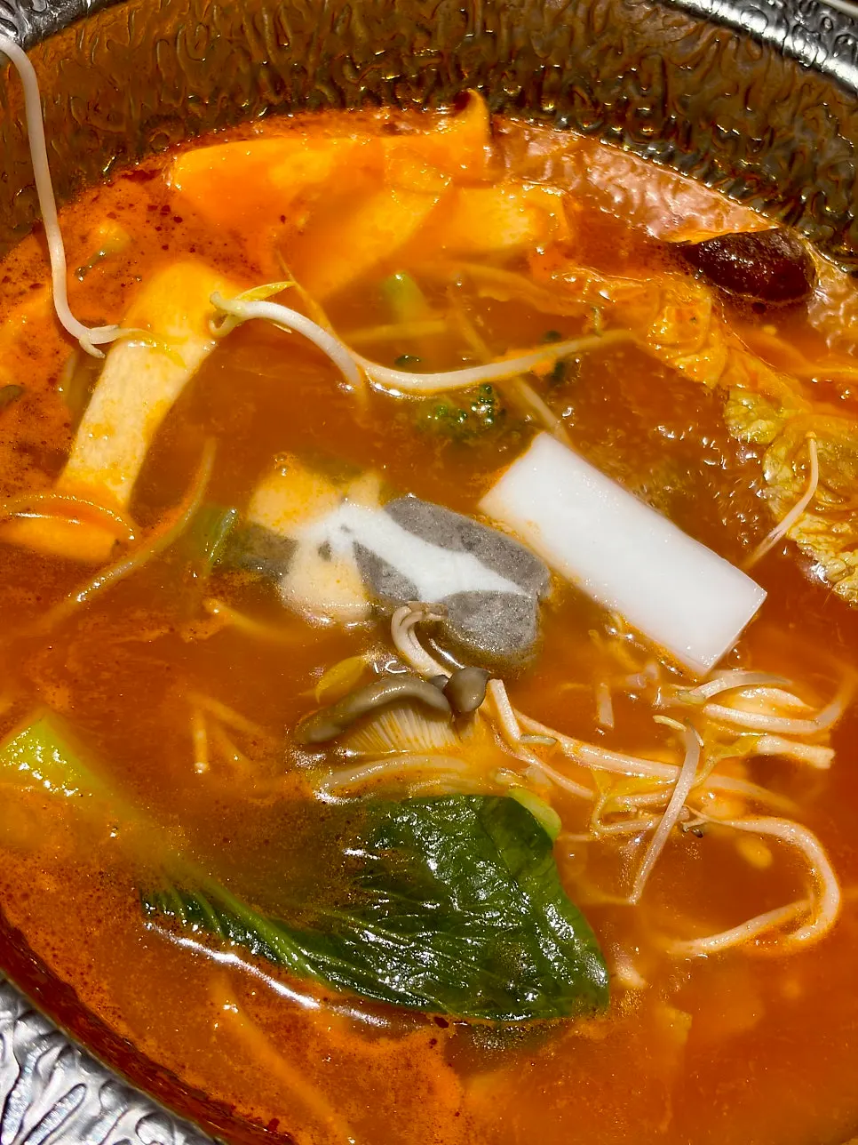 Pot of beef tomato broth loaded with vegetables