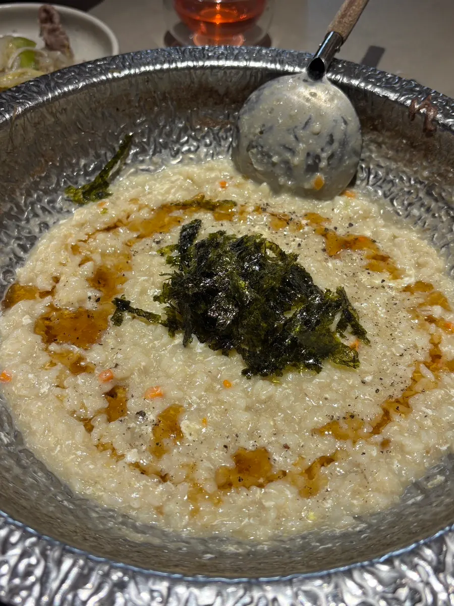 Rice simmering in broth to make egg porridge