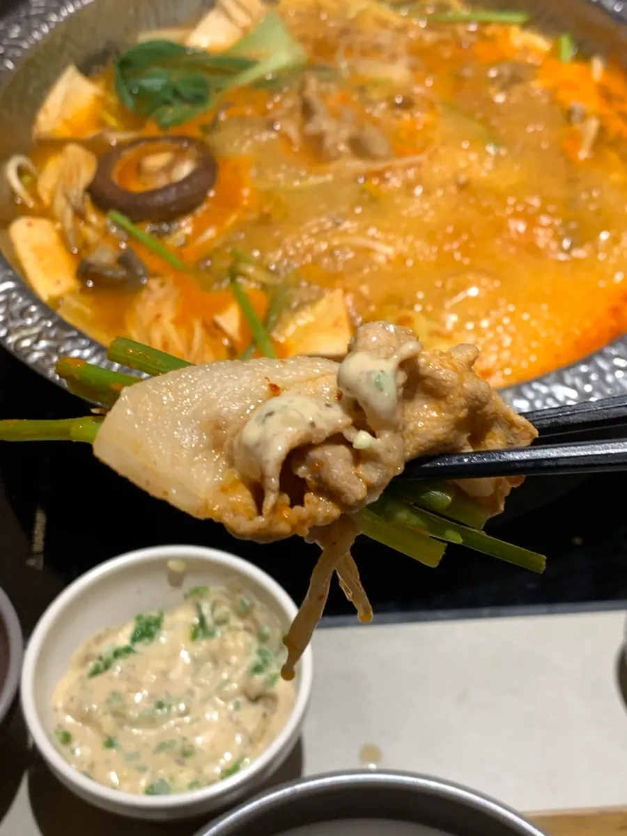 Black pork being cooked in the boiling broth