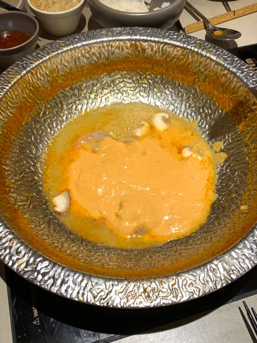 Shabu-shabu pot with more meat added back in to cook