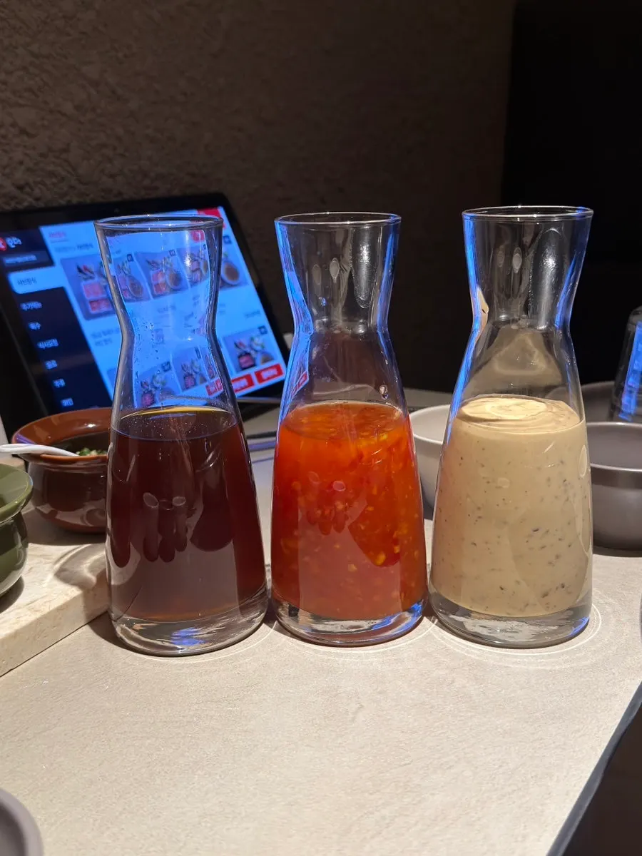 3 shabu sauces plus minced garlic and chili prepared on the table
