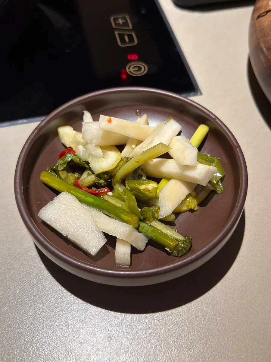 Pot filled with red spicy mushroom broth