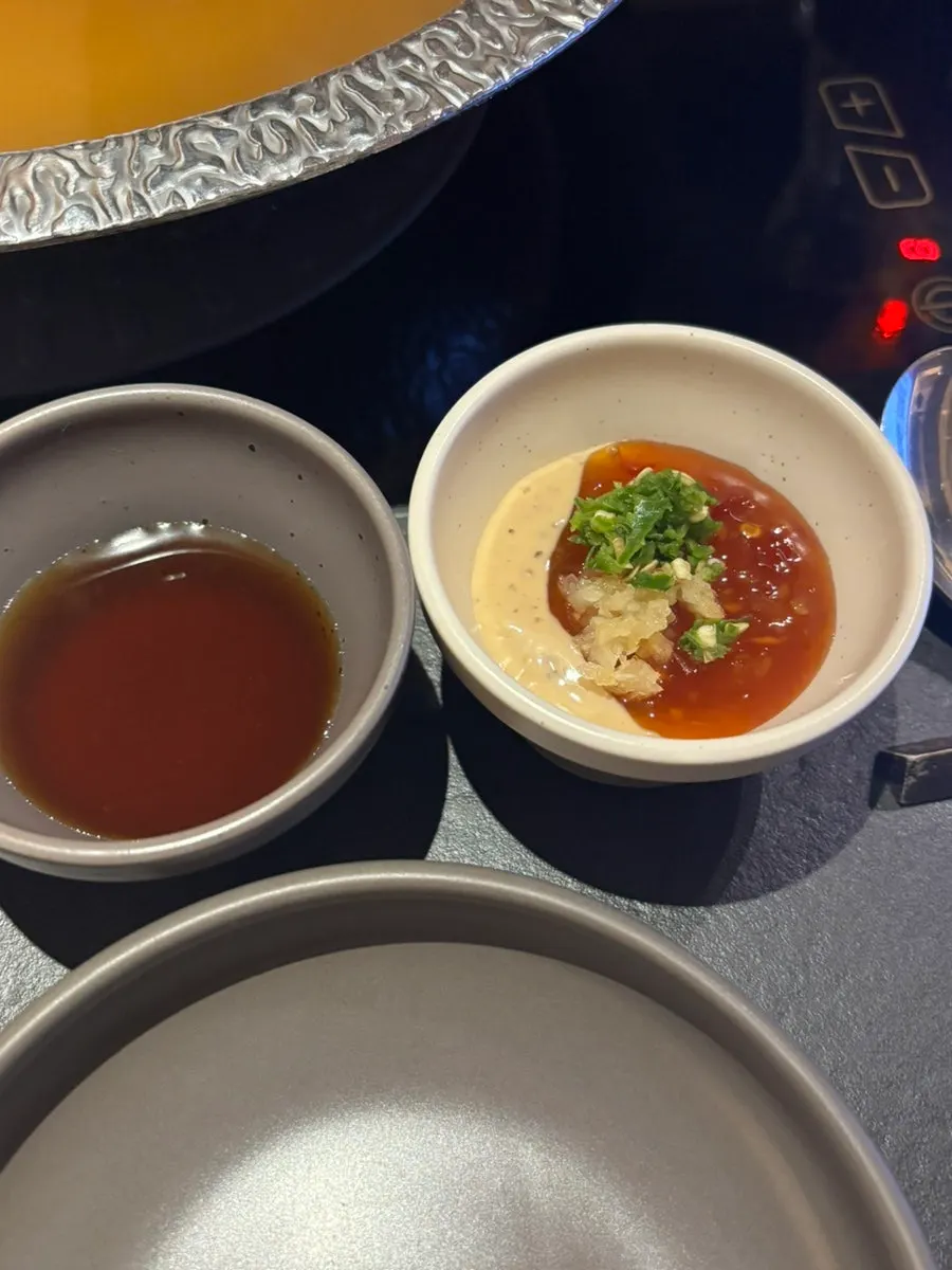 Three personal sauces at Shabu in Seoul with combo instructions written out
