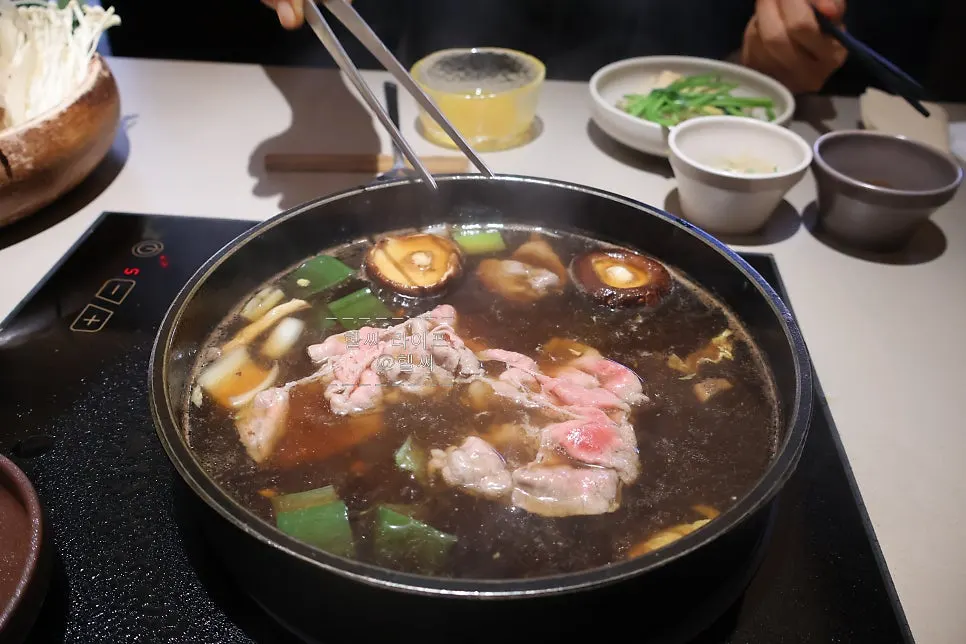 A full spread of sukiyaki enjoyed generously with added assorted mushrooms
