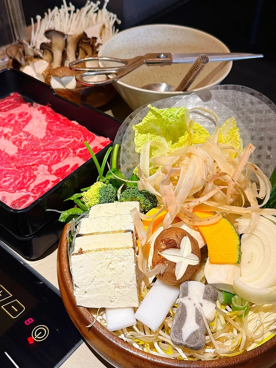 Sukiyaki for two with vegetables and meat set up
