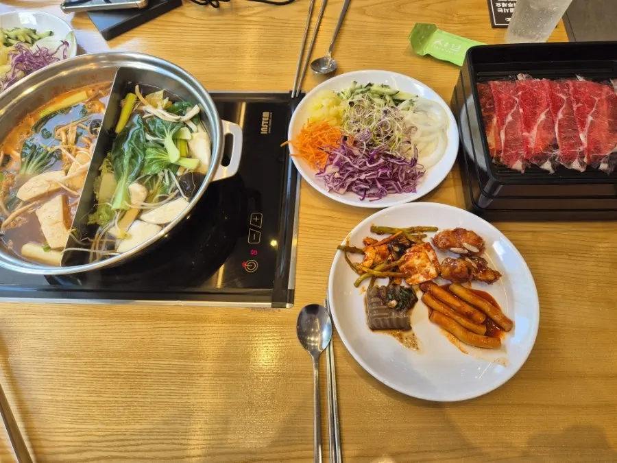 Plates of shabu-shabu ingredients each person picked out