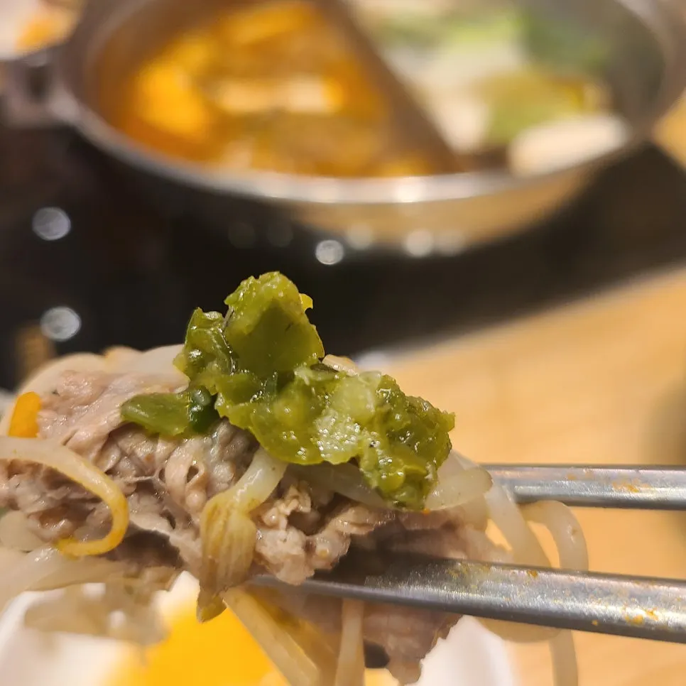 Gochu dadaegi spooned over shabu-shabu meat and vegetables