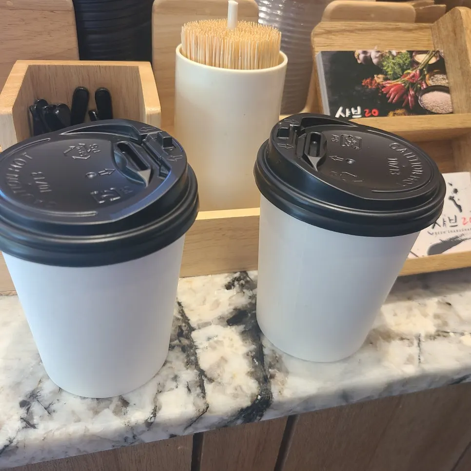 Takeaway cups and lids prepared at the counter