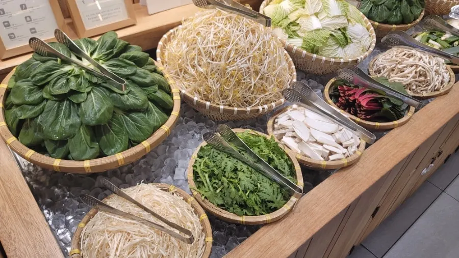 Self-service bar filled with fresh shabu-shabu vegetables