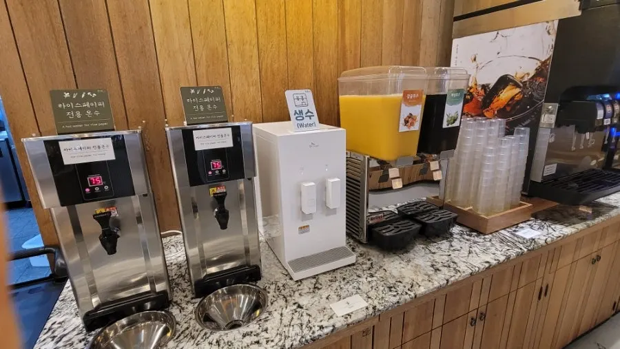 Self-service bar with porridge ingredients, fruit, and rice cakes