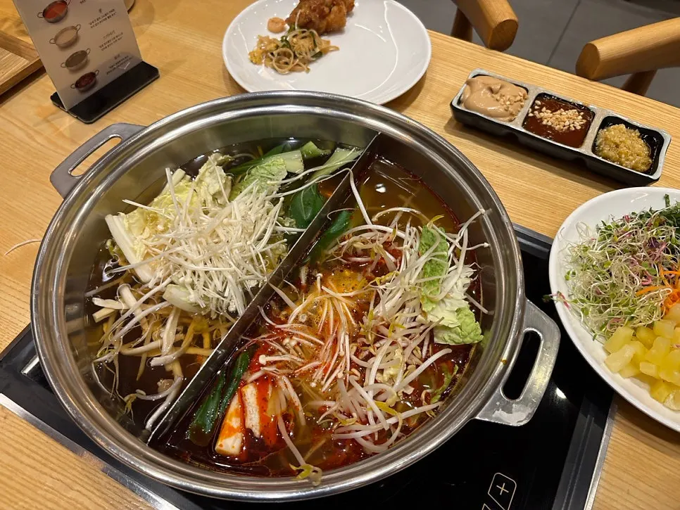 A shabu-shabu pot boiling with ingredients