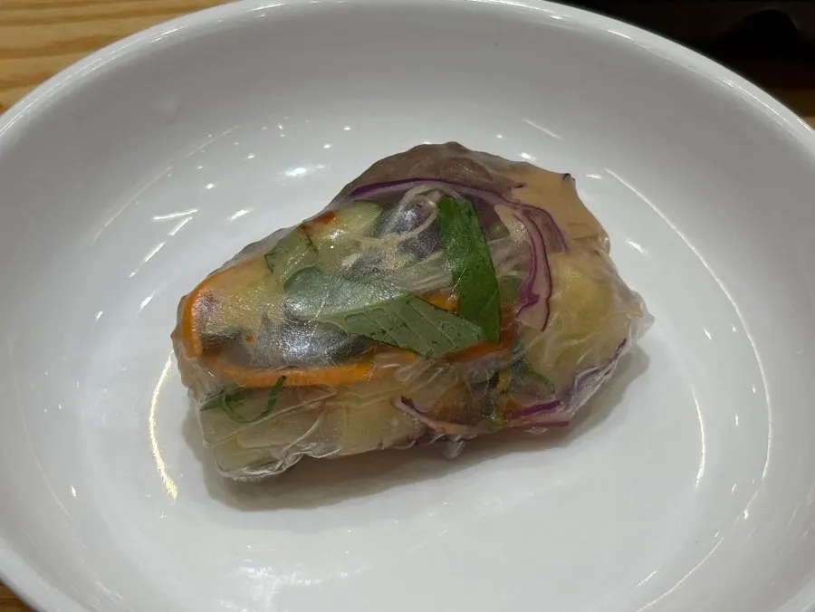 A plate loaded with meat and vegetables for shabu-shabu