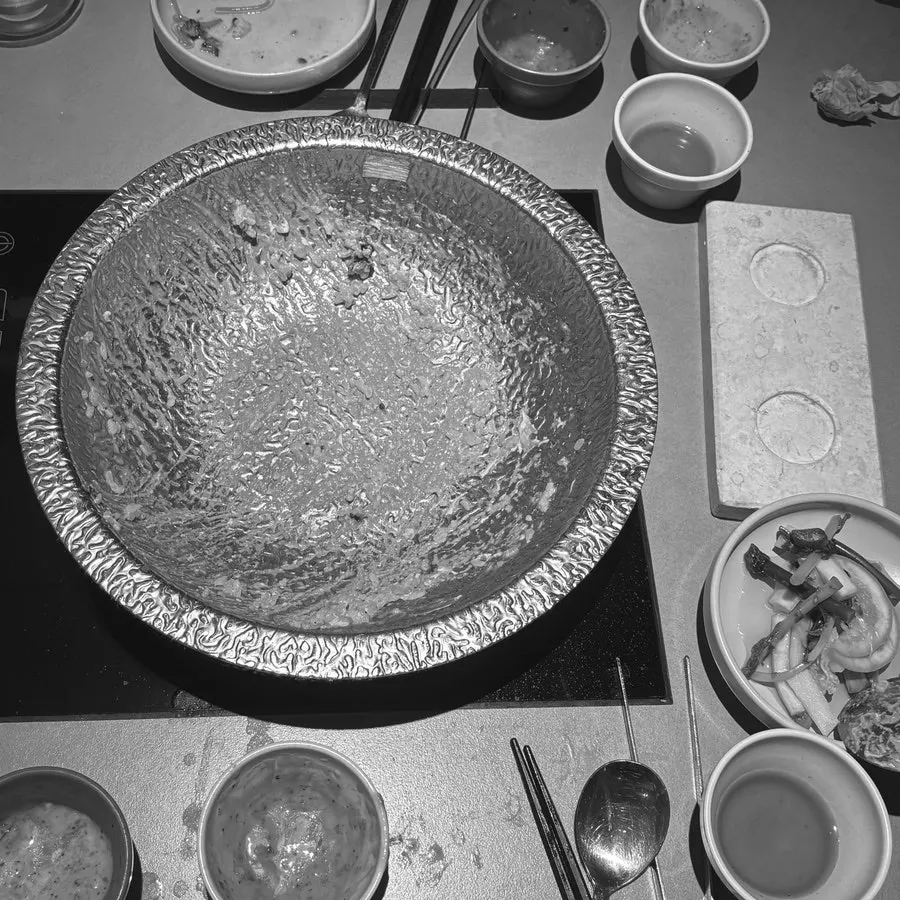 An emptied shabu-shabu pot and dishes