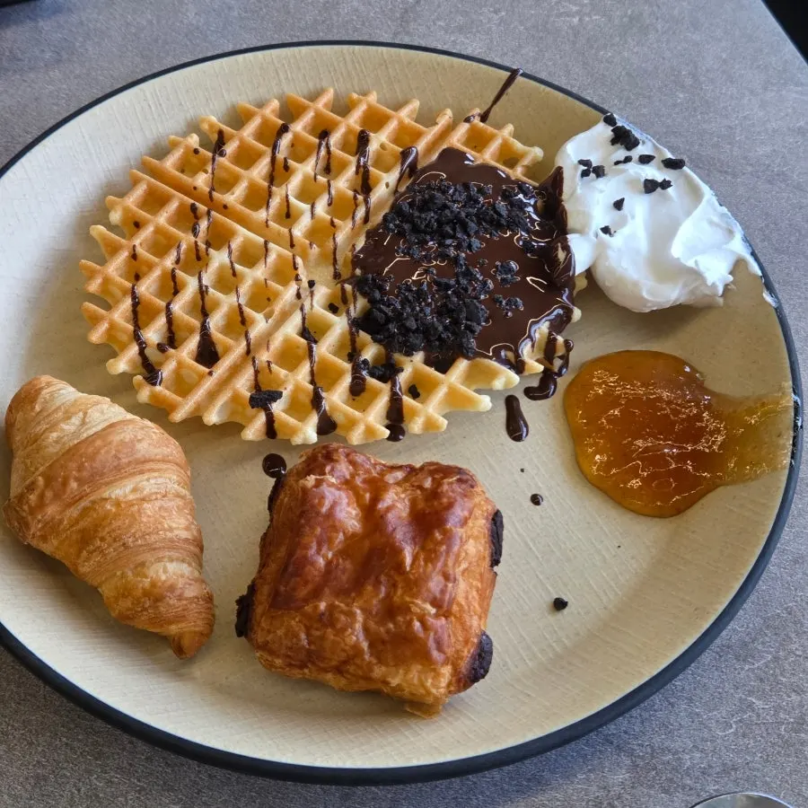Waffle dessert topped with ice cream