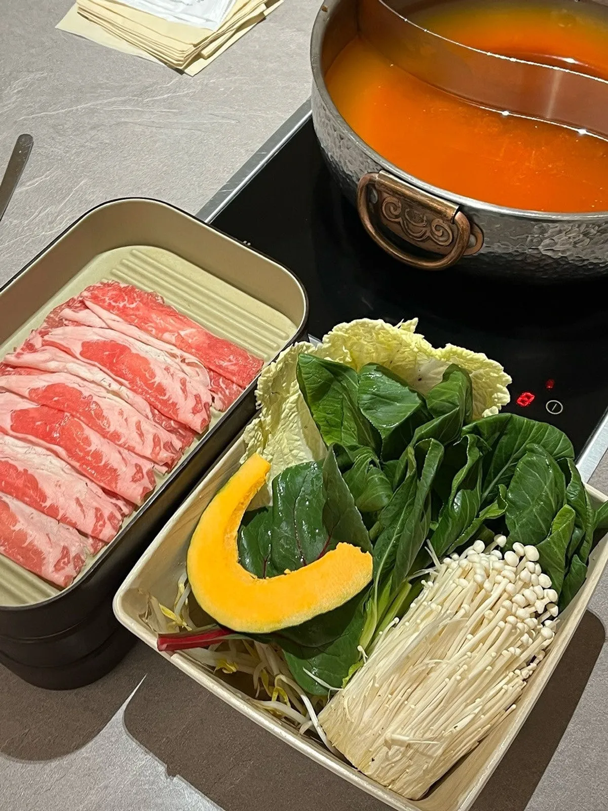 Table set with spicy broth and meat