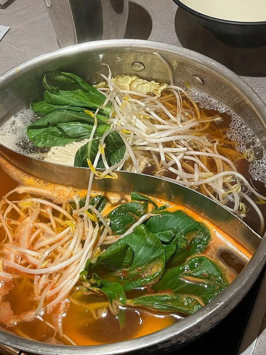 Bean sprouts, bok choy and other vegetables added to the broth