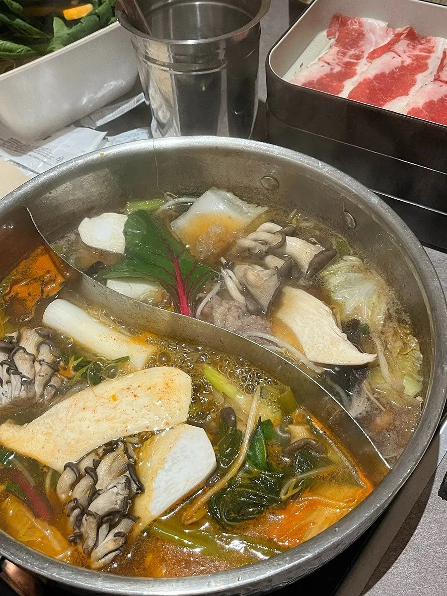 Vegetables simmering in the spicy broth pot