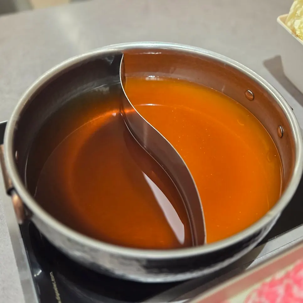 Pot split between clear and spicy broth