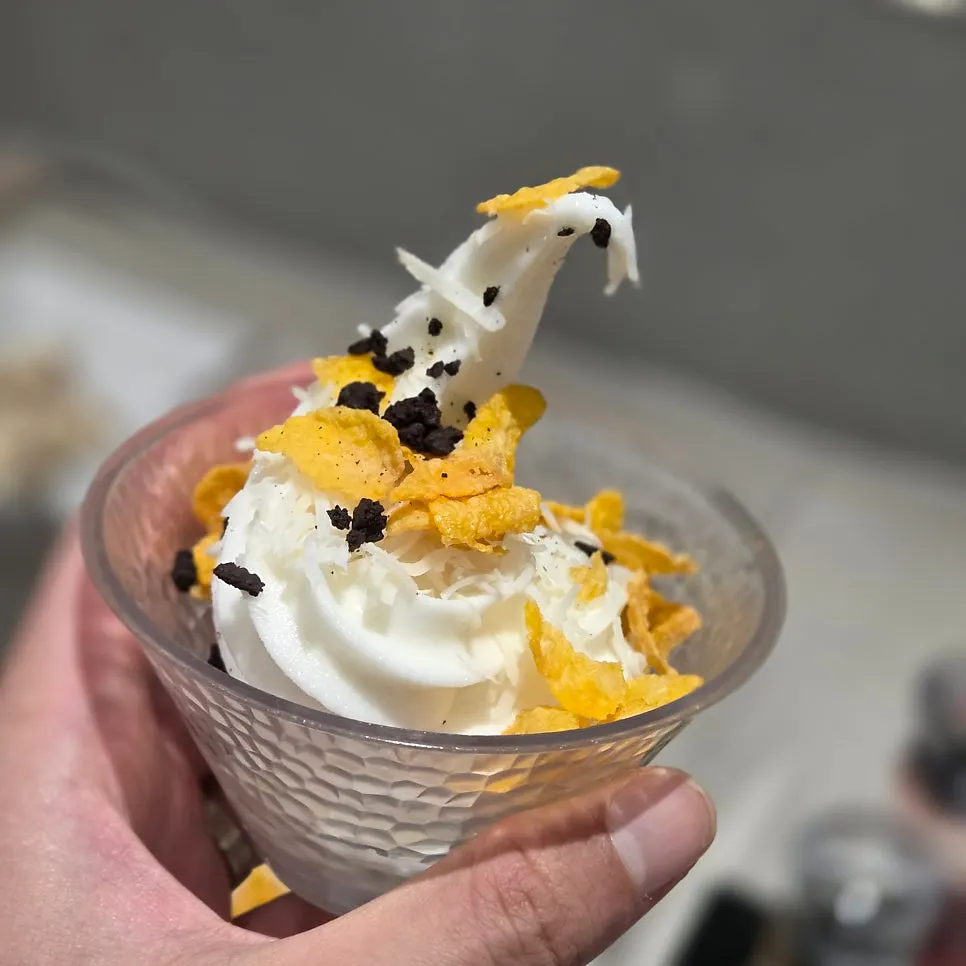Soft-serve ice cream in a glass with cereal topping