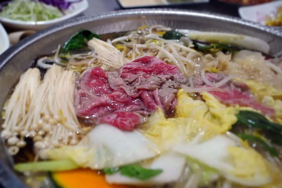 Pot of shabu-shabu simmering with vegetables and meat