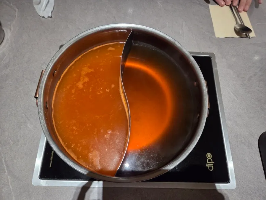Pot with half regular, half spicy broth